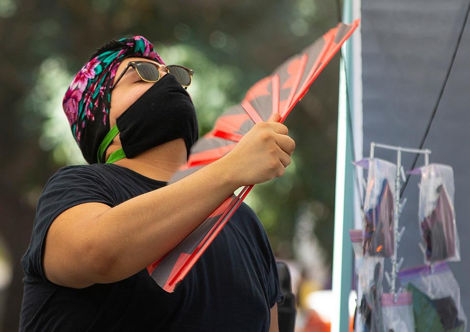 Lord Muro cools himself off while working at the Fluffy Vegans at the Downtown Farmers Market on July 25, 2020.