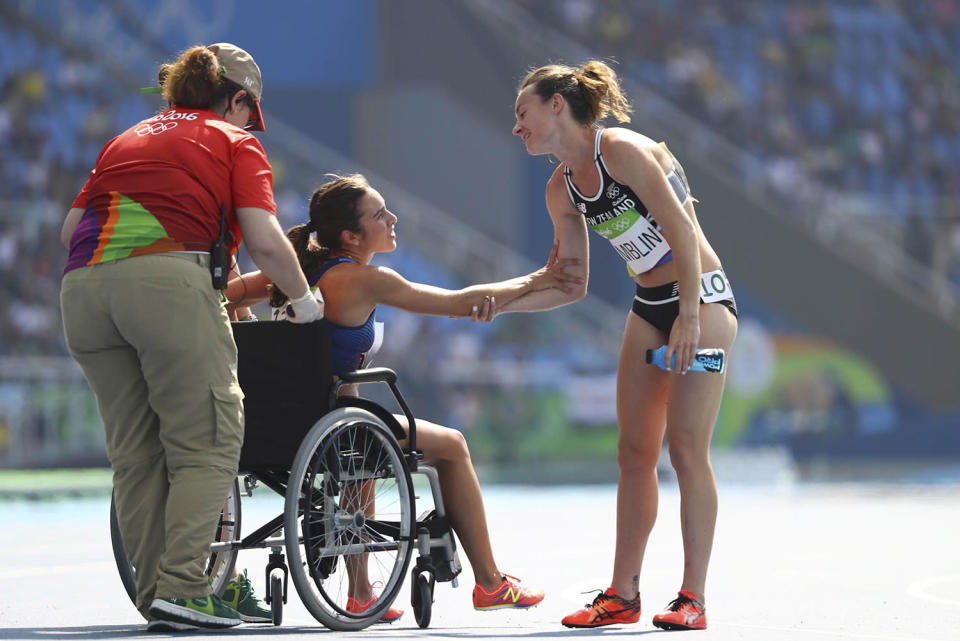 <p>Nikki Hamblin of New Zealand comforts Abbey D’Agostino of USA after the women’s 5000m round 1 race at the Olympic Stadium on August 16, 2016. (REUTERS/Lucy Nicholson) </p>