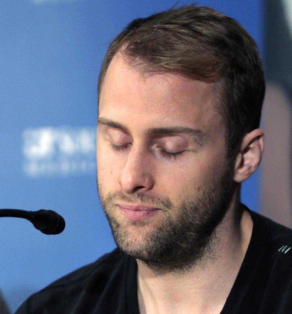 Dallas Stars forward Rich Peverley, right, makes a statement regarding his health and the incident which occurred in a recent NHL game during a news conference at UT Southwestern Medical Center as coach Lindy Ruff looks on Wednesday, March 12, 2014, in Dallas. Peverley will not play again this season after he collapsed on the bench during the game. He was diagnosed with an irregular heartbeat in training camp. (AP Photo/Tim Sharp)