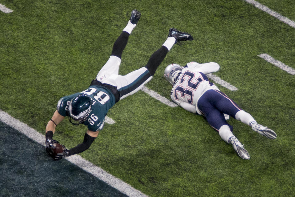 FILE - In this Feb. 4, 2018, file photo, Philadelphia Eagles tight end Zach Ertz (86) dives for a touchdown past New England Patriots safety Devin McCourty (32) in the fourth quarter of the NFL Super Bowl 52 football game in Minneapolis. The Eagles 41-33 victory celebration had to wait for a video review, which upheld that Ertz had already established possession of the ball before he bobbled it on the ground. (AP Photo/Bruce Kluckhohn, File