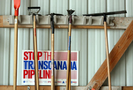 Various anti-pipeline signs line the walls of the machine shed of Art and Helen Tanderup, who are against the proposed Keystone XL Pipeline that would cut through the farm where they live near Neligh, Nebraska, U.S. April 12, 2017. REUTERS/Lane Hickenbottom