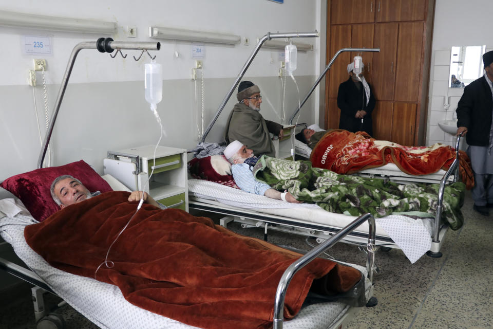 Wounded men receive treatment at a hospital after a roadside bomb blast in Mazar-e Sharif, the capital city of Balkh province, in northern Afghanistan, Tuesday, Dec. 6, 2022. A Taliban official says that a roadside bomb went off near a government bus in northern Afghanistan, killing several people. (AP Photo)