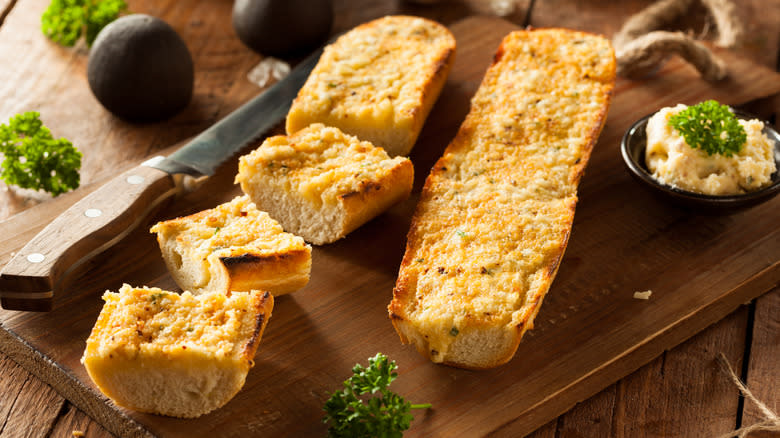 Garlic bread on cutting board