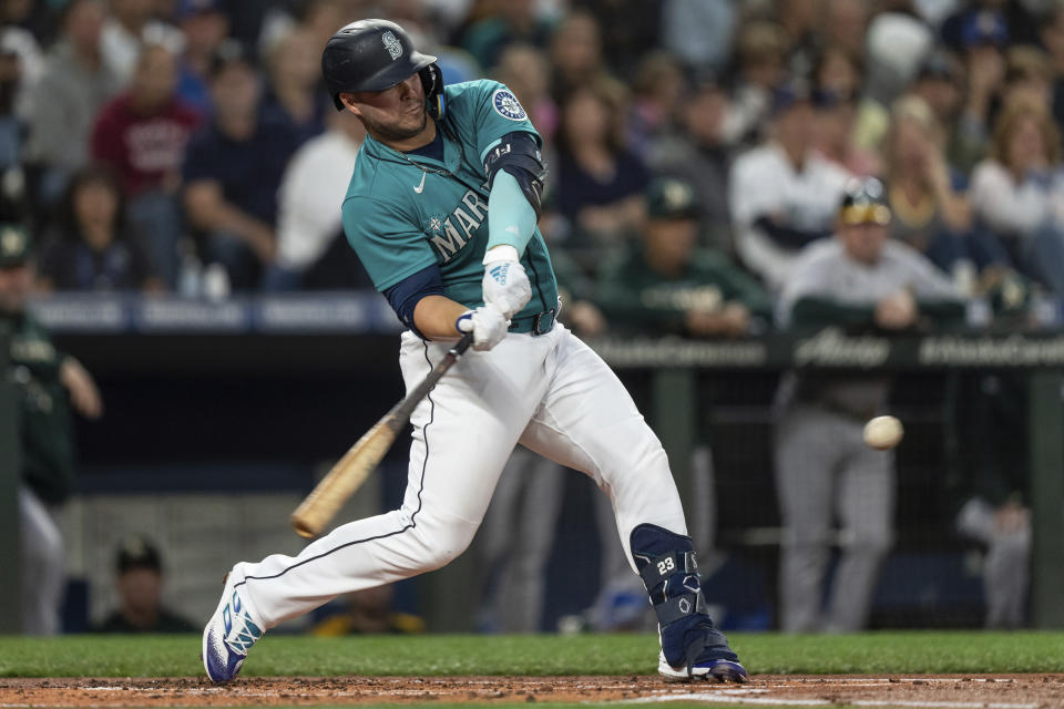 Seattle Mariners' Ty France hits an RBI double off Oakland Athletics starting pitcher Ken Waldichuk during the first inning of a baseball game Friday, Sept. 30, 2022, in Seattle. (AP Photo/Stephen Brashear)