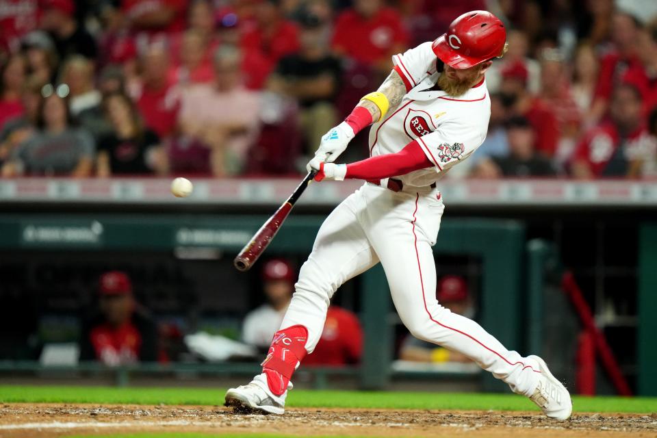 Cincinnati Reds pinch hitter Jake Fraley (27) hits a solo home run during the seventh inning of a baseball game against the Colorado Rockies, Friday, Sept. 2, 2022, at Great American Ball Park in Cincinnati. 