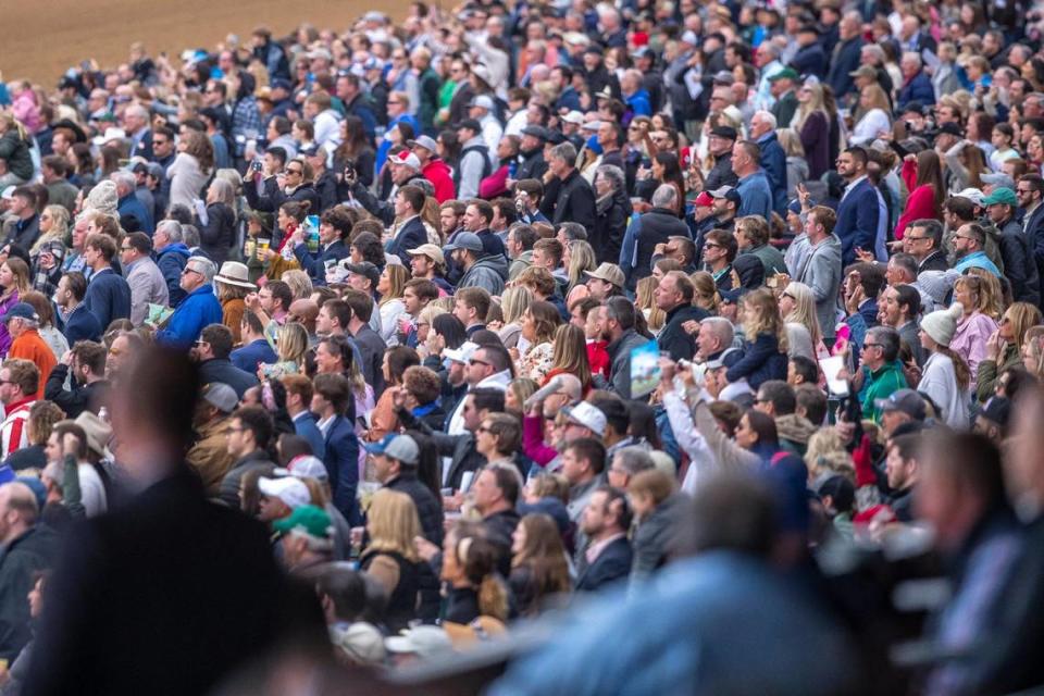 Fans watch a race on the first day of the Spring Meet at Keeneland on Friday.