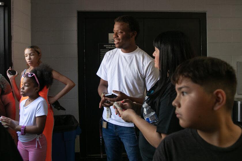 Los Angeles, CA - August 12: Marveon Mabon is a fourth-generation resident of the Imperial Courts public housing project in the city of Watts leads the backpack distribution event for children at the Watts Empowerment Center located in the Imperial Courts Housing Project on Saturday, Aug. 12, 2023 in Los Angeles, CA. (Jason Armond / Los Angeles Times)