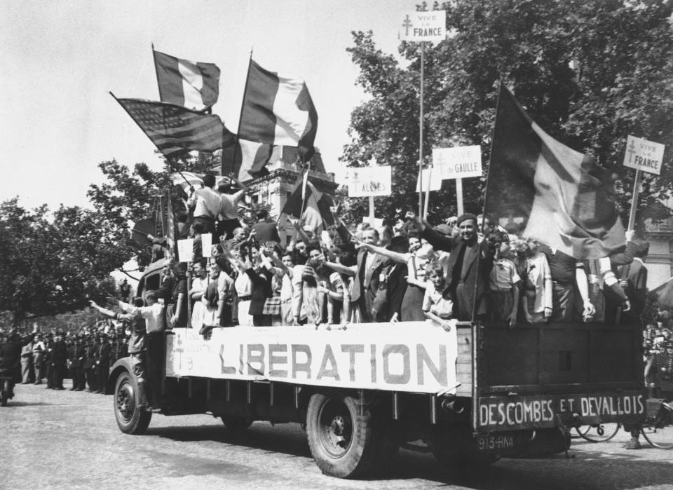 FILE - In this Aug. 28, 1944 file photo, a truck load of Parisians waving flags and carrying Vive De Gaulle banners drives through the streets of a madly rejoicing Paris. The fighting for the liberation of Paris took place from August 19 to August 25, 1944. The French Resistance staged an uprising against the Nazis, leading attacks against German soldiers and vehicles and building barricades in the streets of the French capital. (AP Photo, File)