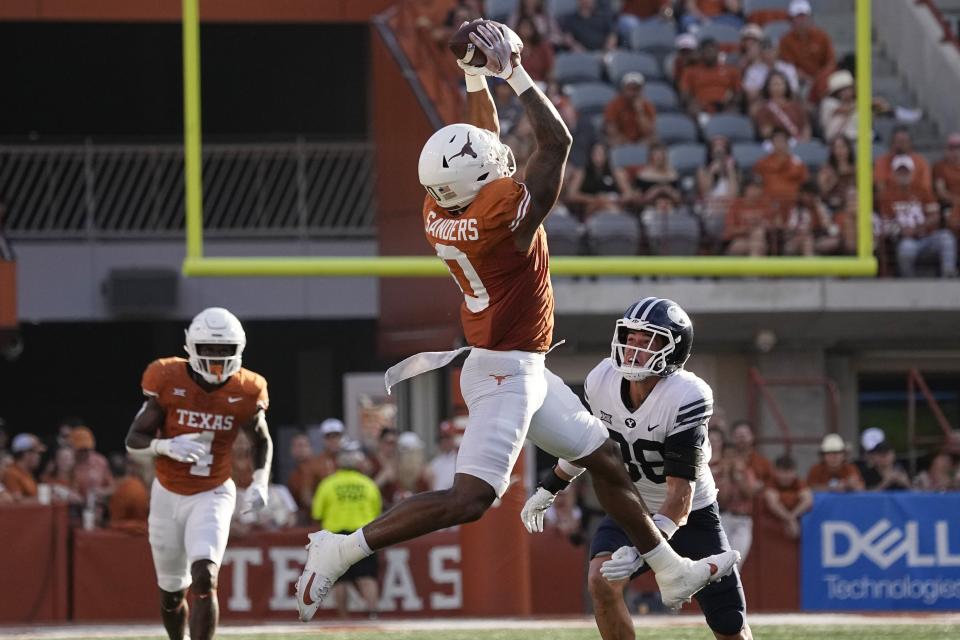 Texas tight end Ja’Tavion Sanders (0) makes a catch over BYU safety Crew Wakley (38) during the second half of an NCAA college football game in Austin, Texas, Saturday, Oct. 28, 2023. | Eric Gay, Associated Press