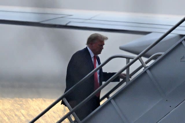 <p>ANDREW CABALLERO-REYNOLDS/AFP/Getty</p> Former President Donald Trump boards his plane after answering to criminal charges in Fulton County, Georgia, on Aug. 24, 2023