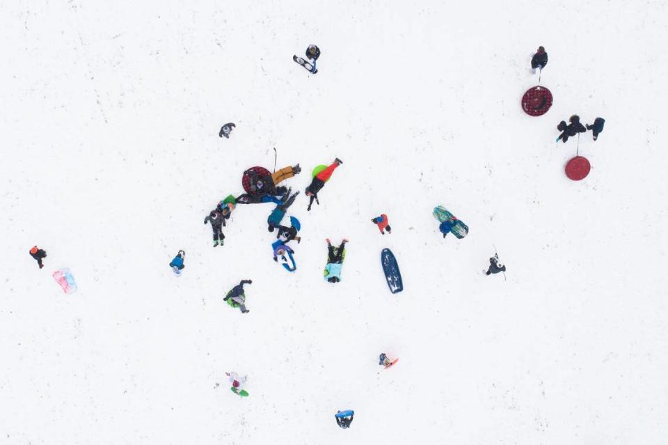 Sledders move up and down the hill at the former Shriners Hospital on Richmond Road following Thursday’s historic snowfall in Lexington, Ky., Friday, Jan. 7, 2022.