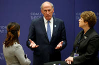 U.S. Director of National Intelligence Dan Coats speaks with aides during the afternoon ministerial plenary for the Global Coalition working to Defeat ISIS at the State Department in Washington, U.S., March 22, 2017. REUTERS/Joshua Roberts