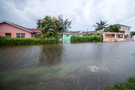 Houses line a flooded street after the effects of Hurricane Dorian arrived in Nassau