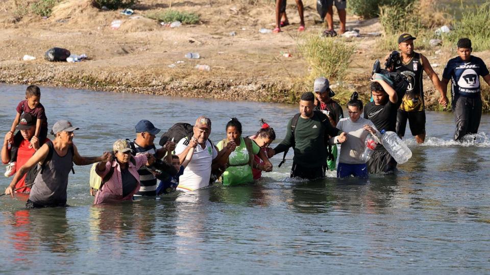 PHOTO: Migrants cross the Rio Grande in Eagle Pass, Texas, on Sept. 22, 2023. (Adam Davis/EPA via Shutterstock)