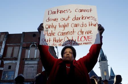 Barbara Carter of Tuscaloosa holds a sign as she waits to join a commemorative march across the Edmund Pettus Bridge in Selma, Alabama, in this file photo taken January 18, 2015. REUTERS/Tami Chappell