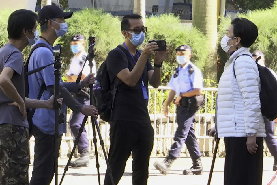 In this photo taken from video, Garry Pang Moon-yuen is seen outside the West Kowloon Court on Nov. 29, 2021. Pang and another Hong Konger were found guilty on a sedition charge on Thursday, Oct. 27, 2022, after they clapped and criticized the judge during a previous trial over a banned Tiananmen Square vigil in the city. (AP Photo/Alice Fung)