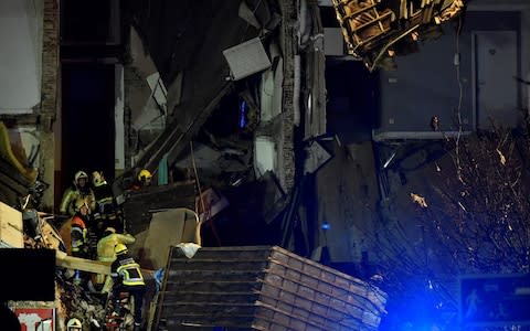 Firefighters inspect a collapsed building - Credit: Dirk Waem/AFP