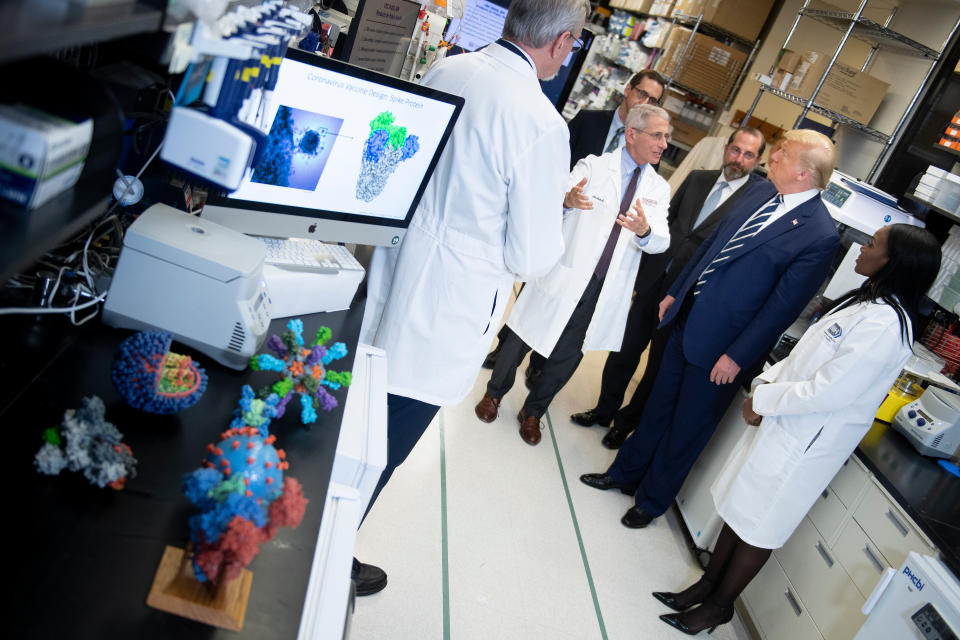 National Institute of Allergy and Infectious Diseases Director Tony Fauci speaks to US President Donald Trump during a tour of the National Institutes of Health's Vaccine Research Center (Getty Images)