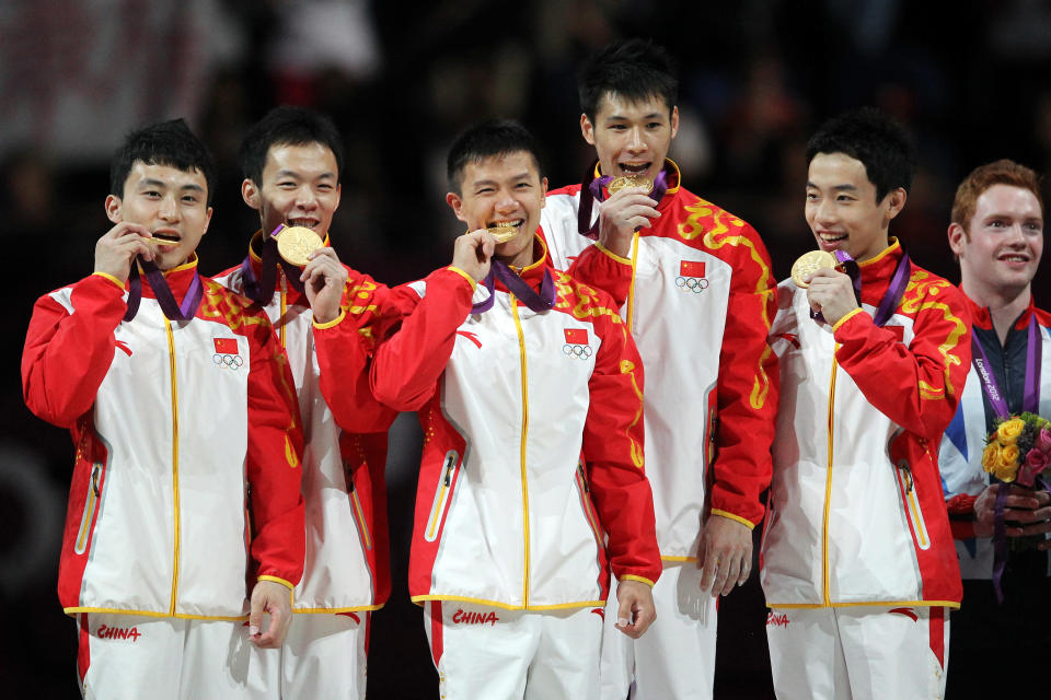 LONDON, ENGLAND - JULY 30: Gold medalists Zhe Feng, Weiyang Guo, Yibing Chen, Chenglong Zhang and Kai Zou of China celebrate on the podium during the medal ceremony in the Artistic Gymnastics Men's Team final on Day 3 of the London 2012 Olympic Games at North Greenwich Arena on July 30, 2012 in London, England. (Photo by Streeter Lecka/Getty Images)