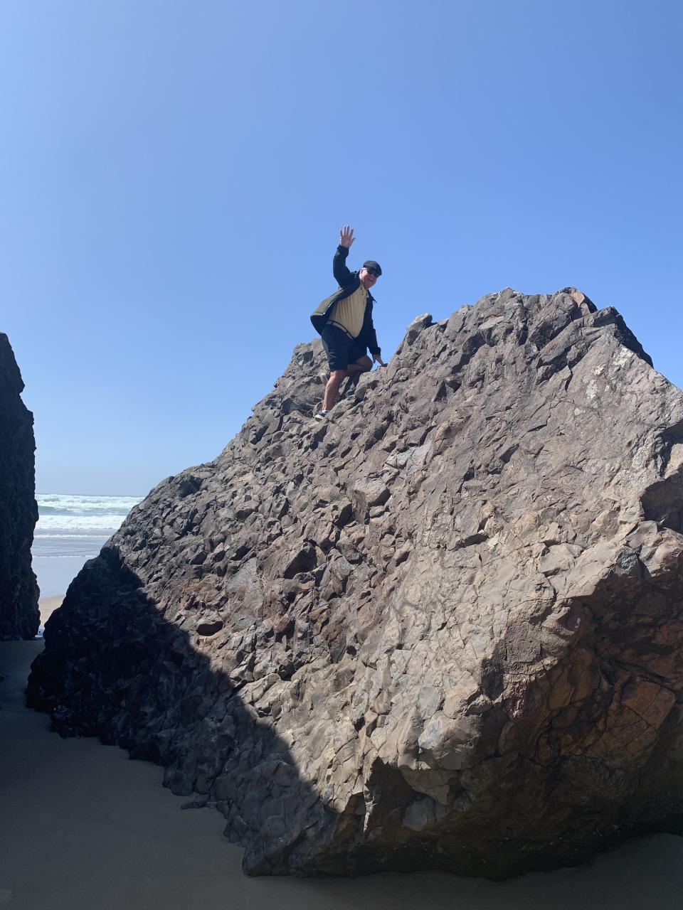 Candace's husband, Bruce, is being a kid again climbing the boulders at Arch Cape Beach off Highway 101 on the coast of Oregon.