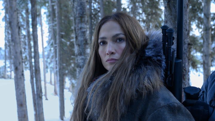 Jennifer Lopez as The Mother standing in a snowy forest looking to her left in The Mother.