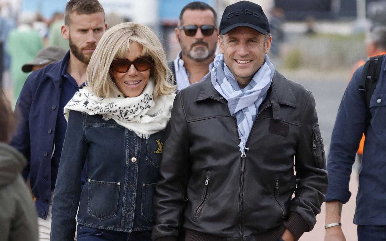 France's President Emmanuel Macron (R) and his wife first lady Brigitte Macron (L) walk along the beach during an air show in Le Touquet-Paris-Plage, northern France, on June 29, 2024. (Photo by Ludovic MARIN / AFP) (Photo by LUDOVIC MARIN/AFP via Getty Images)