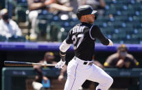 Colorado Rockies' Trevor Story connects for an RBI-single off San Diego Padres starting pitcher Yu Darvish in the first inning of the first game of a baseball doubleheader Wednesday, May 12, 2021, in Denver. (AP Photo/David Zalubowski)