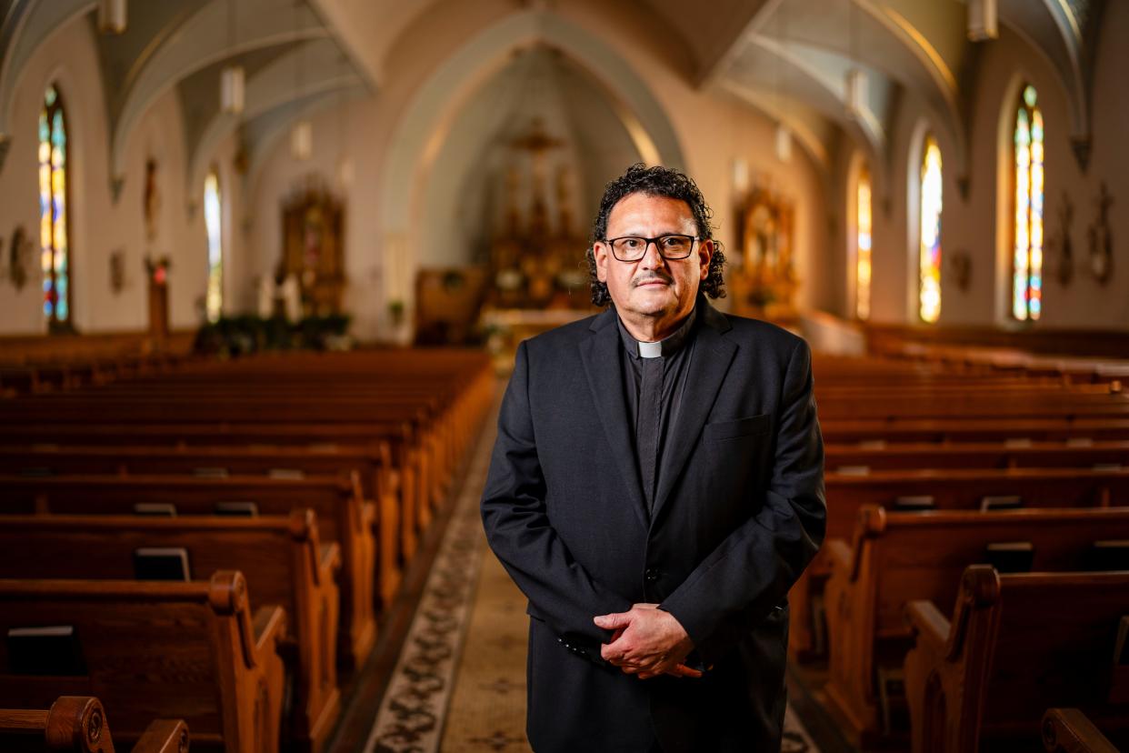 Father Nils Hernandez stands for a photo at the Queen of Peace Catholic Church in Waterloo, Wednesday, April 24, 2024.