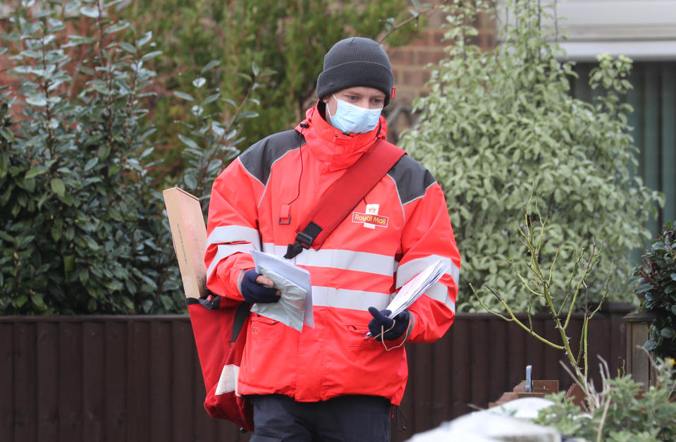 A Royal Mail delivery worker in Ashford, Kent, during England's third national lockdown to curb the spread of coronavirus.