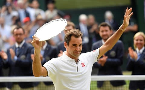 Roger Federer with the runners up trophy after losing the final  - Credit: REUTERS