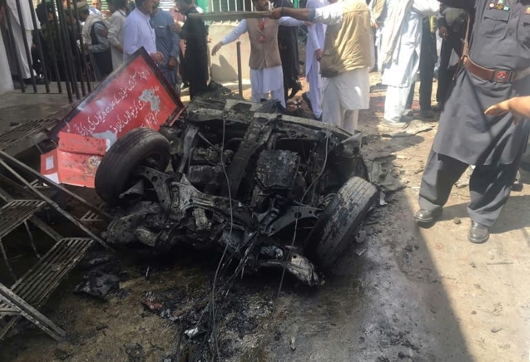 Pakistanis gather at the site of a bomb blast at a market in Parachinar, capital of the Kurram tribal district, on March 31, 2017