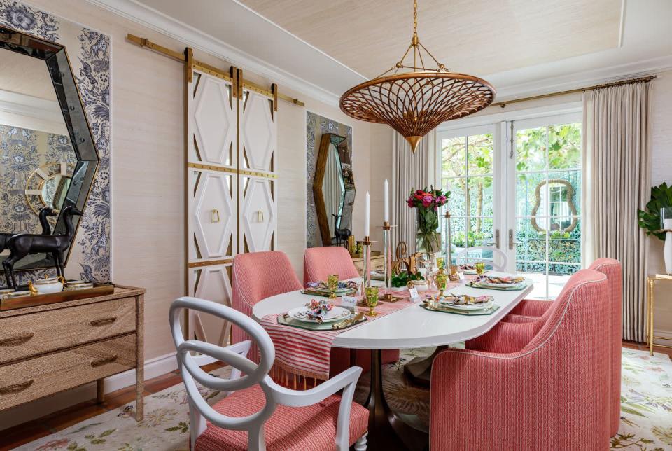 <p>Designer Lorna Gross was inspired to create a dining space that felt like a fantasy—something experiential with a story. Once she fell for a whimsical, woodland-creature-laden wallpaper by <a href="https://clarke-clarke.sandersondesigngroup.com/" rel="nofollow noopener" target="_blank" data-ylk="slk:Clarke & Clarke" class="link ">Clarke & Clarke</a> through <a href="https://www.kravet.com/fabric" rel="nofollow noopener" target="_blank" data-ylk="slk:Kravet" class="link ">Kravet</a>, a pair of fawn sculptures, and a bronze and bamboo chandelier by <a href="https://www.curreyandcompany.com/" rel="nofollow noopener" target="_blank" data-ylk="slk:Currey & Company" class="link ">Currey & Company</a>, Gross knew she was onto something out of a fairytale. The space soon became a menagerie of all these darling pieces—from <a href="https://jonathanadler.com/" rel="nofollow noopener" target="_blank" data-ylk="slk:Jonathan Adler" class="link ">Jonathan Adler</a> salt-and-pepper shakers shaped like turtles to dragonfly-shaped napkin rings from <a href="https://kimseybert.com/" rel="nofollow noopener" target="_blank" data-ylk="slk:Kim Seybert" class="link ">Kim Seybert</a>—that reflect a colorful wonderland. </p><p>The designer then worked with <a href="https://www.newmoonrugs.com/" rel="nofollow noopener" target="_blank" data-ylk="slk:New Moon Rugs" class="link ">New Moon Rugs</a> to design a custom floral rug inspired by Elizabethan needlework and late Renaissance design to tie the space together. The finishing touch, says Gross, was creating the custom sliding doors to ensure the mess inside the kitchen didn't distract from a magical dining experience with Tinkerbell and friends. </p>