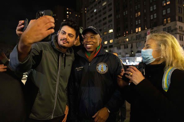 New York City Mayor-elect Eric Adams takes a selfie with a supporter after lighting the 