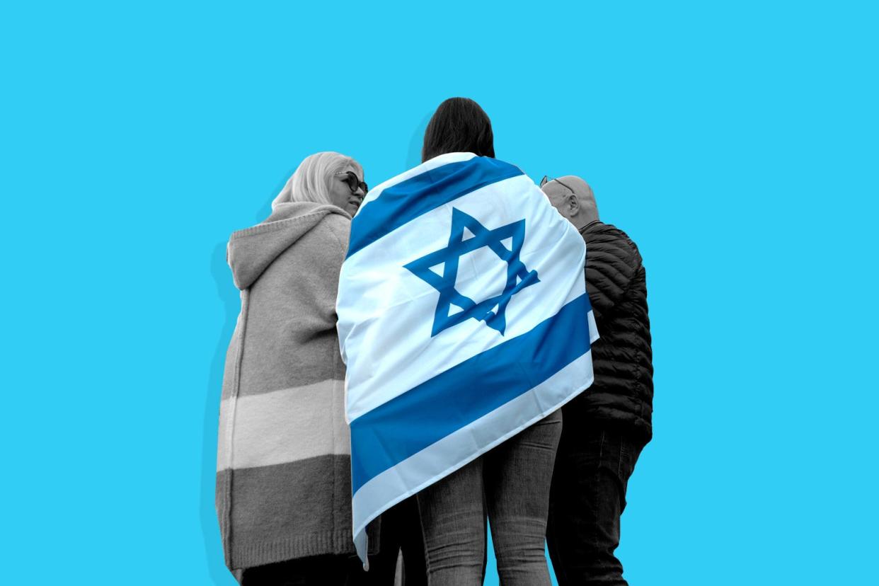 A person with a Jewish flag draped over their back with two other people on either side.