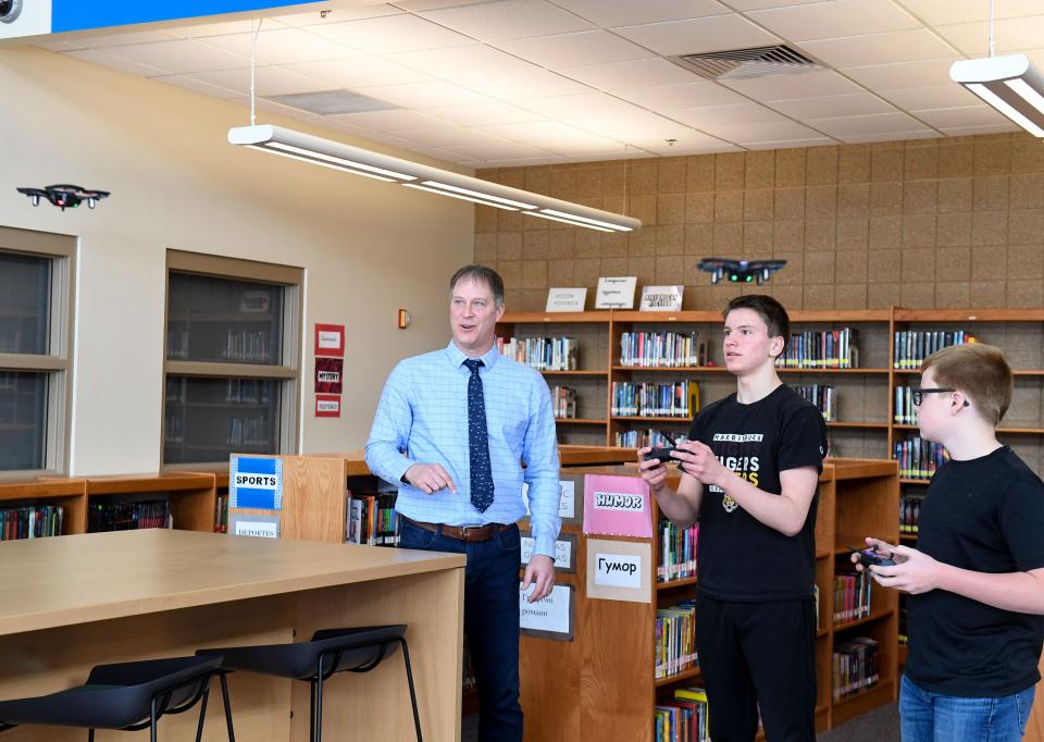 Darren Ellwein, principal at South Middle School, checks in on eighth graders Connor Albers and Caleb Bachmeier as they fly drones on Friday, March 1, 2023, in Harrisburg.