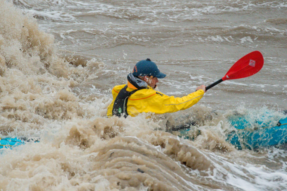 The inclement weather didn't put some people off their usual activities, like this kayaker in Clevedon, Somerset. (SWNS)