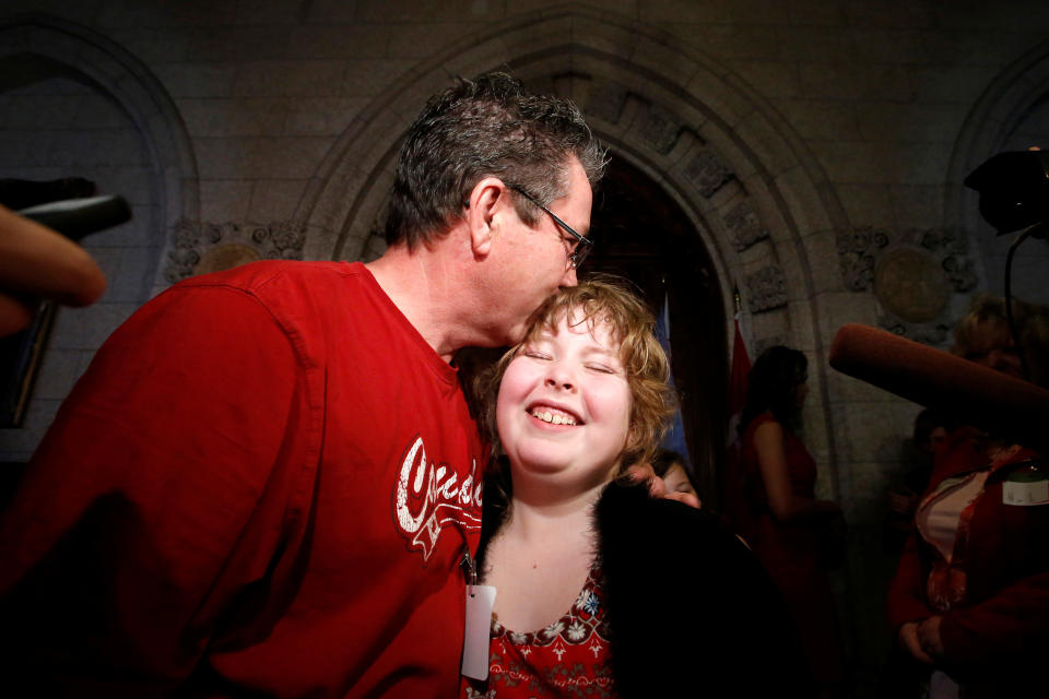 Charlie Lowthian-Rickert, 10, who is transgender, is kissed by her father Chris on Parliament Hill in Ottawa, Canada, on May 17, 2016, following a news conference announcing that Canada would introduce legislation to protect transgender people from discrimination and hate crimes.