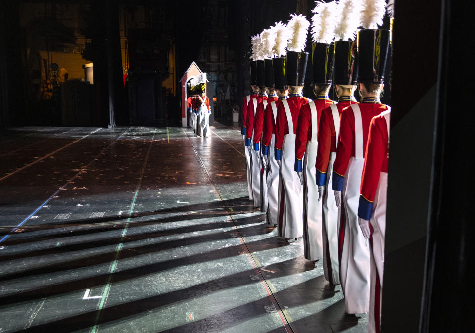 In this Monday, Nov. 25, 2019 photo Rockette Sydney Mesher, first in line at right, takes the stage as a Wooden Solider during a performance of the Christmas Spectacular at Radio City Music Hall in New York. Mesher, who was born without a left hand due to the rare congenital condition symbrachydactyly, is the first person with a visible disability ever hired by New York's famed Radio City Rockettes. (AP Photo/Craig Ruttle)