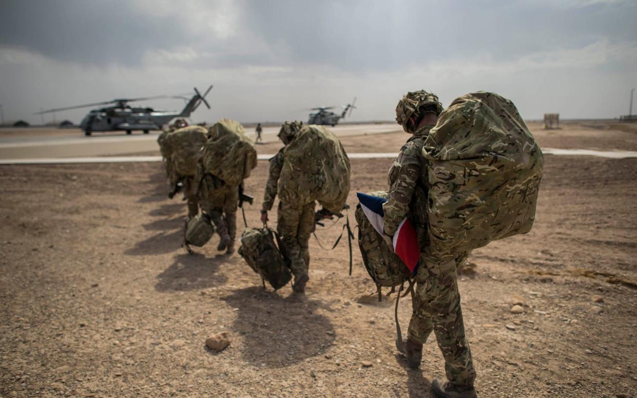 Carrying the Union Jack, the last British troops leave Camp Bastion, Helmand Province, Afghanistan - Ben Birchall 