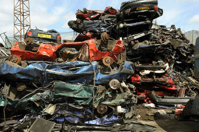 A pile of crushed cars piled high in a breaker's yard in Neasden north west London, where Metropolitan Police officers checked cars in a breaker's yard in Harrow, North West London, after a rise in older cars being stolen and crushed for their scrap metal value and then being shipped overseas.