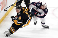 Pittsburgh Penguins' Jesse Puljujarvi (18) and Columbus Blue Jackets' Carson Meyer eye the puck during the first period of an NHL hockey game in Pittsburgh, Thursday, March 28, 2024. (AP Photo/Gene J. Puskar)