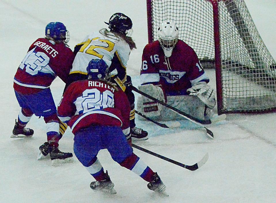 Janel Lloyd of the Watertown Lakers pushes the puck past Brookings Rangers goaltender Aletha Baker during their South Dakota Amateur Hockey Association varsity girls game on Saturday, Dec. 3, 2022 in the Maas Ice Arena. Also defending on the play are Brookings' Jayda Geraets and Taryn Richter.
