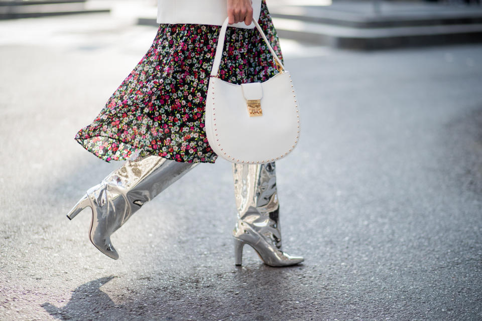 MILAN, ITALY - FEBRUARY 21: Alexandra Lapp wearing a long flower dress from H&M, silver shiny boots by H&M, a long white blazer from Zara, a lacquer waist belt in white and black from Balmain, a white Patricia Hobo bag with studs and sunglasses from Le Specs in pink seen during Milan Fashion Week Fall/Winter 2018/19 on February 21, 2018 in Milan, Italy. (Photo by Christian Vierig/Getty Images)