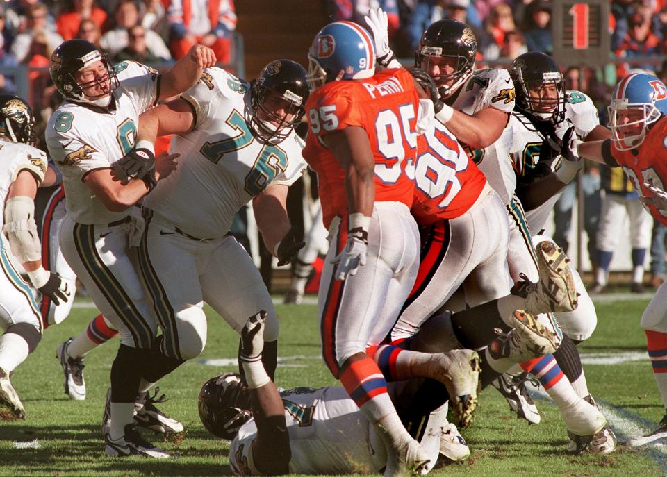 Jacksonville Jaguars guard Rich Tylski protects quarterback Mark Brunell from an oncoming rush of Denver Broncos defenders during their Jan. 4, 1997, playoff game at Mile High Stadium in Colorado.