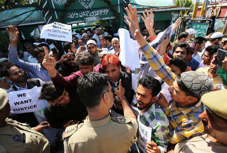 People scuffle with police at a protest against the rape and murder of an eight-year-old girl, in Kathua, outside a mosque in Jammu, April 13, 2018. REUTERS/Mukesh Gupta