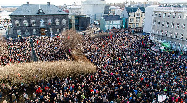 Tens of thousands march outside the Althing, Iceland's parliament. Source: AAP