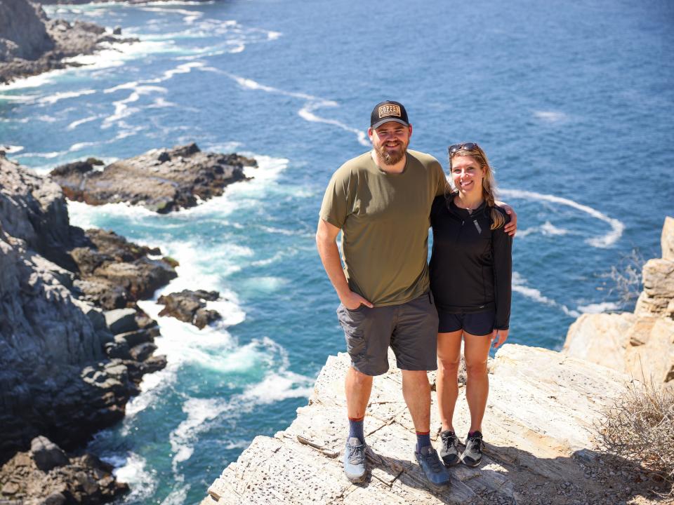 A couple standing on a cliffside