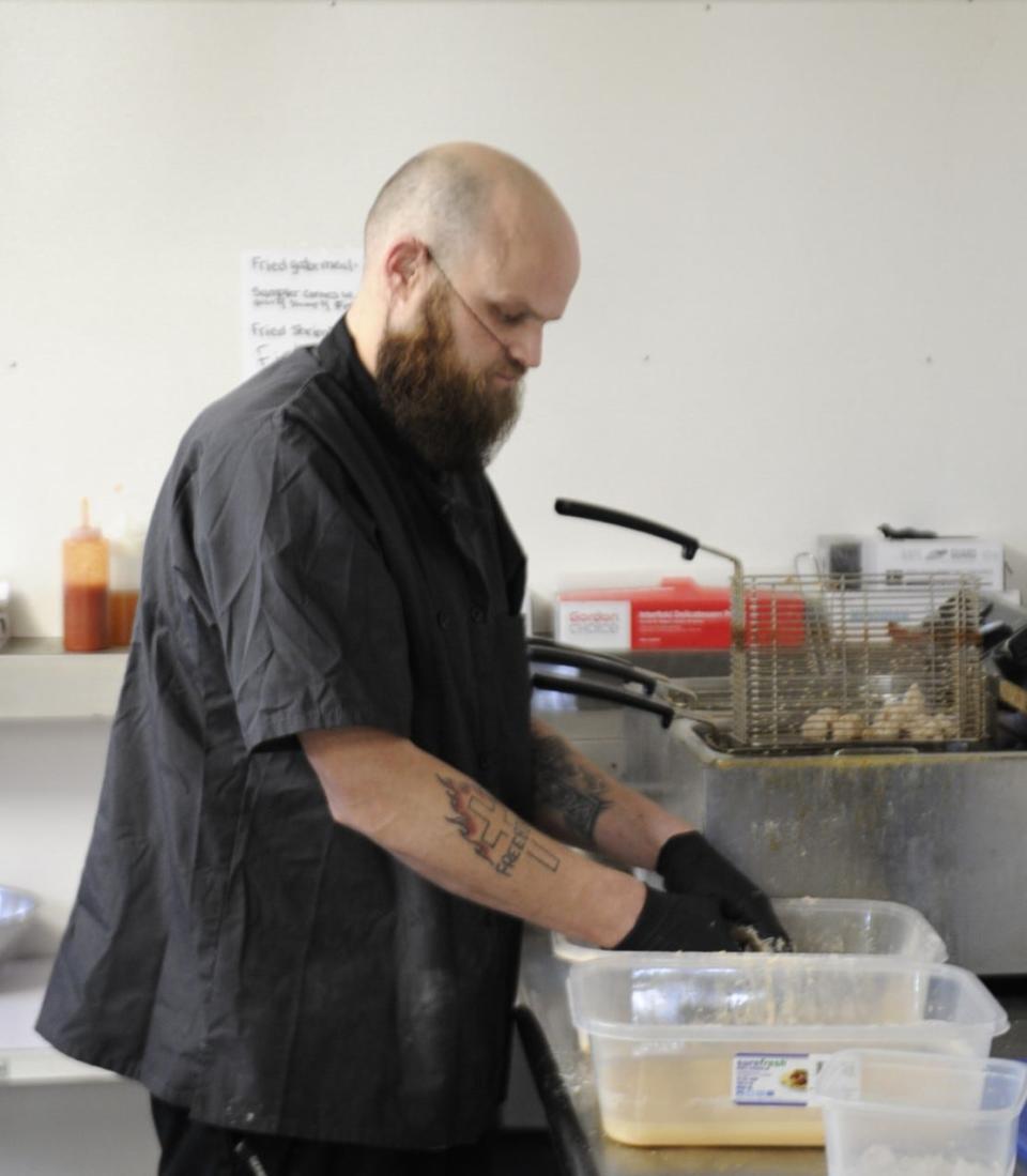 Kenneth Smith dredges shrimp for frying inside Jan's Place on Monday, March 18, 2024.