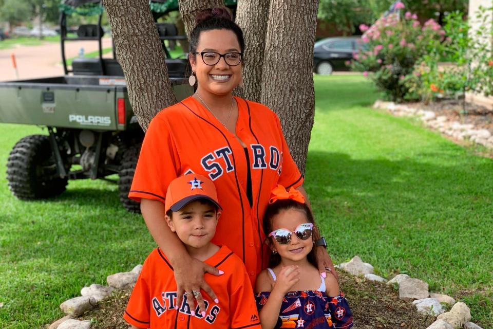 Maria Castillo, centre, with her son Josiah McIntyre, left, and daughter Alayna Flores (AP)