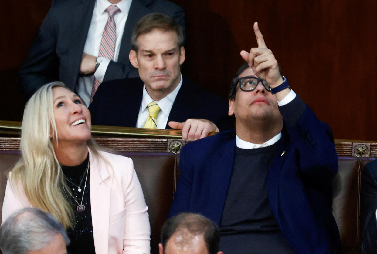Newly elected freshman Rep. George Santos (R-NY), facing a scandal over his resume and claims he made on the campaign trail, points to the ceiling of the House Chamber as he talks with Rep. Jim Jordan (R-OH) and Rep. Marjorie Taylor Greene (R-GA) during a 9th round of votes for the new Speaker of the House on the third day of the 118th Congress at the U.S. Capitol in Washington, U.S., January 5, 2023. REUTERS/Evelyn Hockstein     TPX IMAGES OF THE DAY